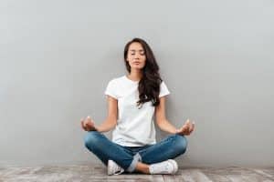 A woman practices meditation in recovery.