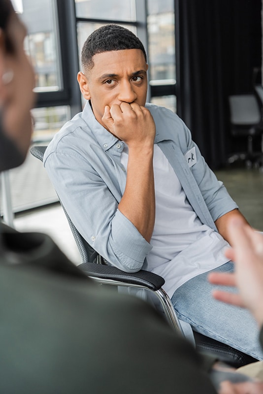 A man participates in therapy at a heroin addiction treatment center.