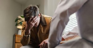 Man upset in therapy after asking is ptsd a disability.